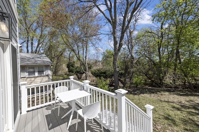wooden deck with a lawn
