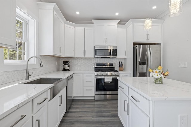 kitchen featuring decorative backsplash, stainless steel appliances, and white cabinetry