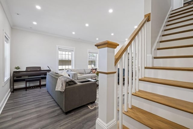 living room featuring recessed lighting, dark wood finished floors, ornamental molding, and stairway