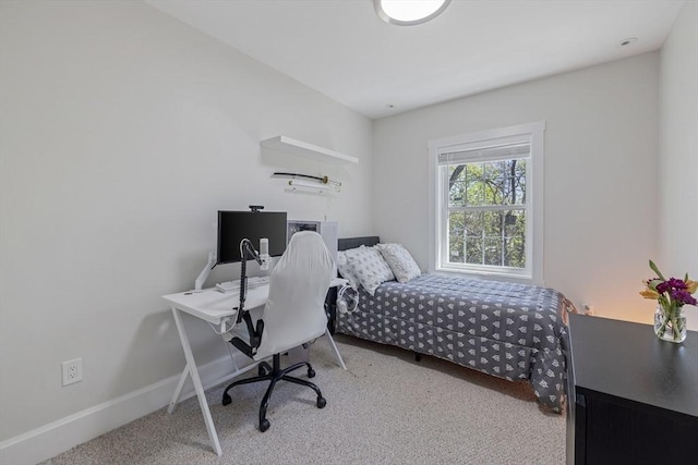 bedroom featuring baseboards and carpet