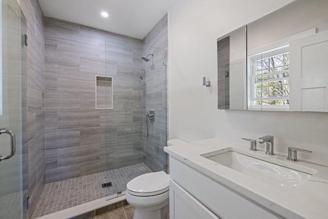 full bathroom featuring toilet, recessed lighting, a shower stall, and vanity