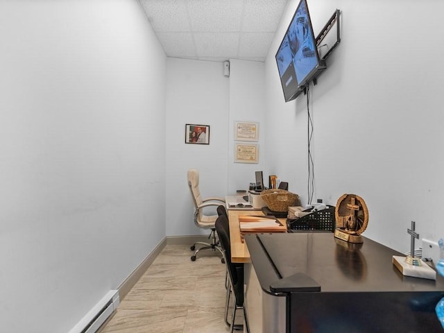 office featuring baseboards, baseboard heating, and a paneled ceiling