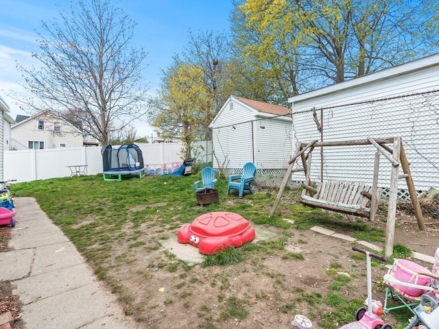 view of yard featuring a fenced backyard and a trampoline