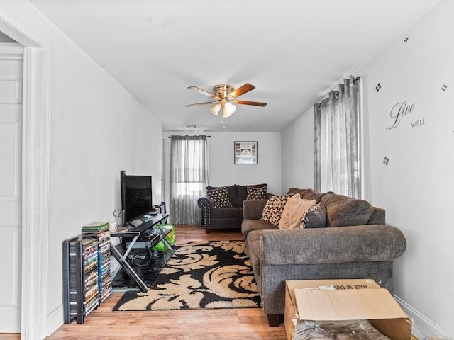 living room featuring ceiling fan and wood finished floors