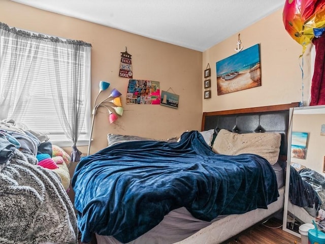 bedroom with wood finished floors