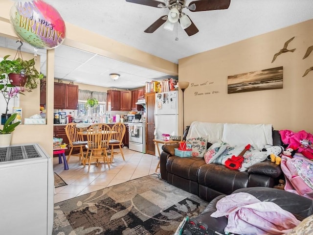 living room featuring ceiling fan and light tile patterned floors