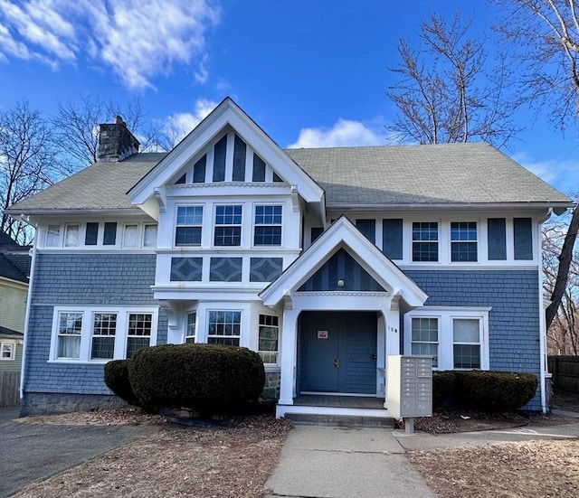 128 Mill St, Springfield, MA 01108 - view of front of home featuring roof with shingles and a chimney