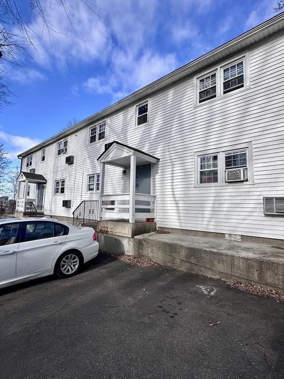 128 Mill St, Springfield, MA 01108 - view of front of house featuring cooling unit and a wall mounted air conditioner