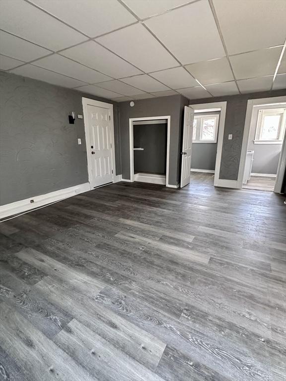 128 Mill St, Springfield, MA 01108 - interior space with dark wood-style flooring, baseboards, and a drop ceiling