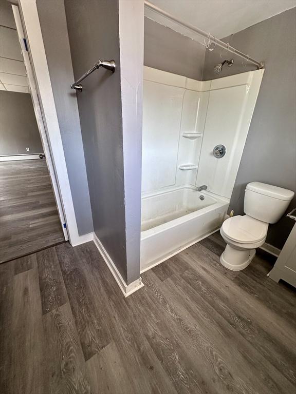 128 Mill St, Springfield, MA 01108 - bathroom with baseboards, wood finished floors, toilet, and shower / washtub combination