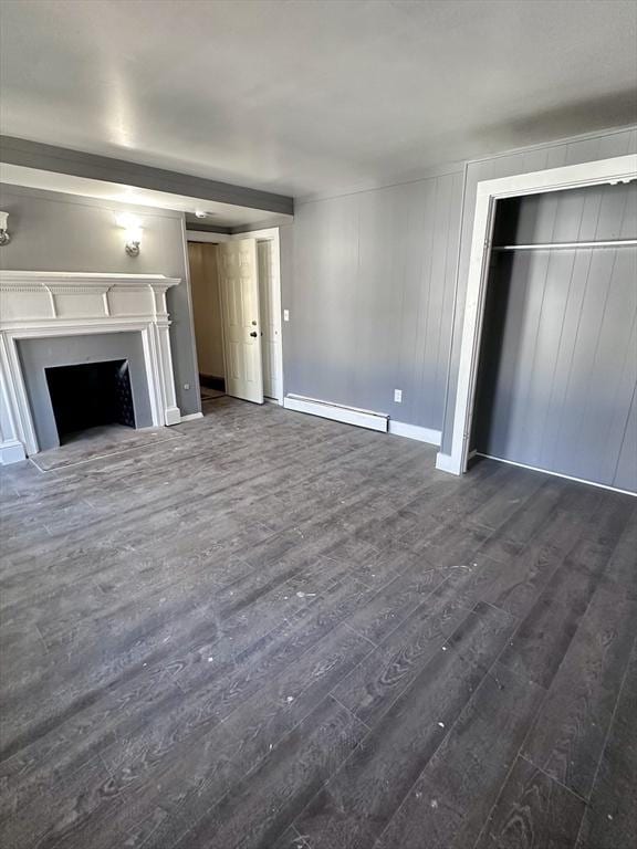 128 Mill St, Springfield, MA 01108 - unfurnished living room featuring a fireplace, dark wood-style flooring, baseboards, and a baseboard radiator
