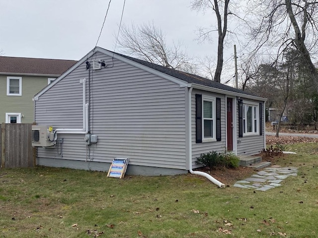 view of home's exterior featuring ac unit and a yard