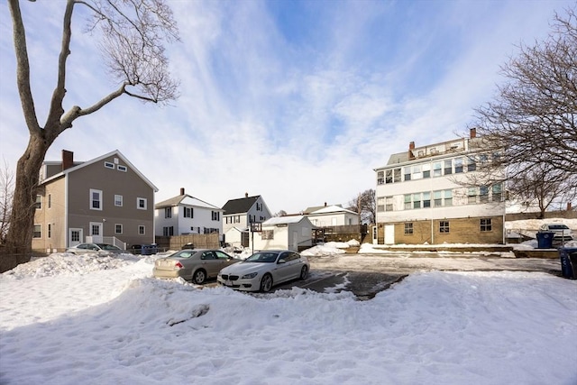 yard covered in snow with a residential view