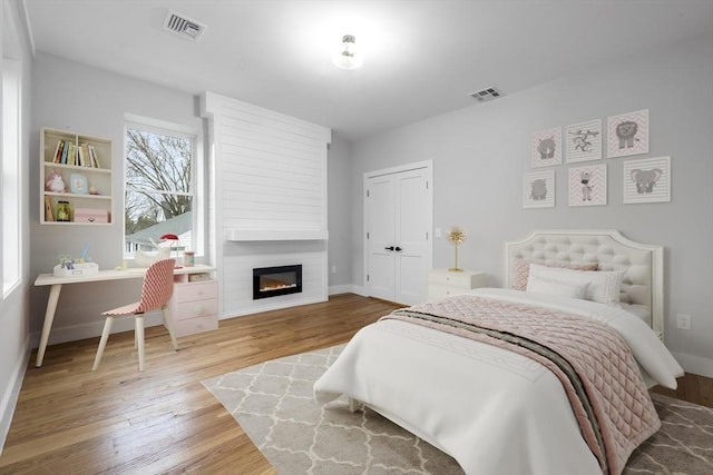1442 Washington St, Canton, MA 02021 - bedroom with wood finished floors, a large fireplace, and baseboards