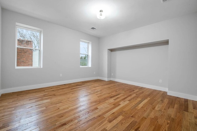 1442 Washington St, Canton, MA 02021 - empty room featuring plenty of natural light, light wood-style flooring, and baseboards