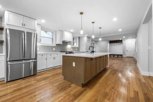 1442 Washington St, Canton, MA 02021 - kitchen featuring freestanding refrigerator, white cabinetry, light countertops, light wood finished floors, and range