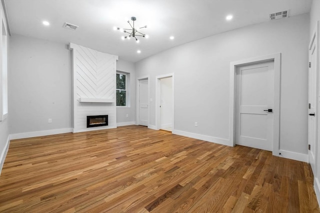 1442 Washington St, Canton, MA 02021 - unfurnished living room with a chandelier, light wood-type flooring, a fireplace, baseboards, and recessed lighting
