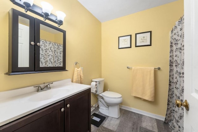 bathroom with hardwood / wood-style flooring, toilet, and vanity