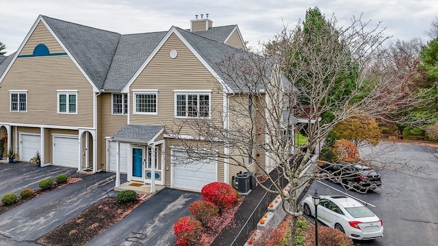 view of front of home featuring central AC unit and a garage