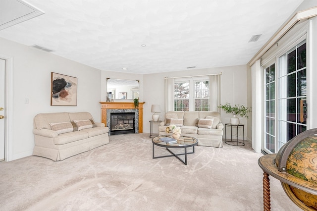 living room featuring light carpet and a fireplace