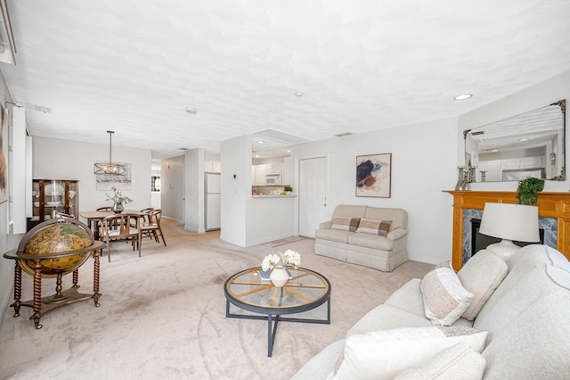 carpeted living room featuring a premium fireplace