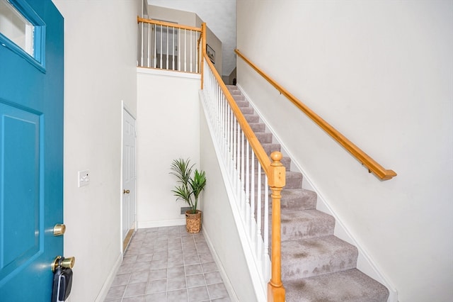 stairs featuring tile patterned floors