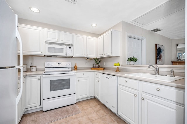 kitchen with white cabinetry, sink, white appliances, and light tile patterned flooring