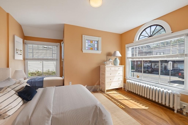 124 Boston Ave, Medford, MA 02155 - bedroom featuring radiator heating unit and wood finished floors