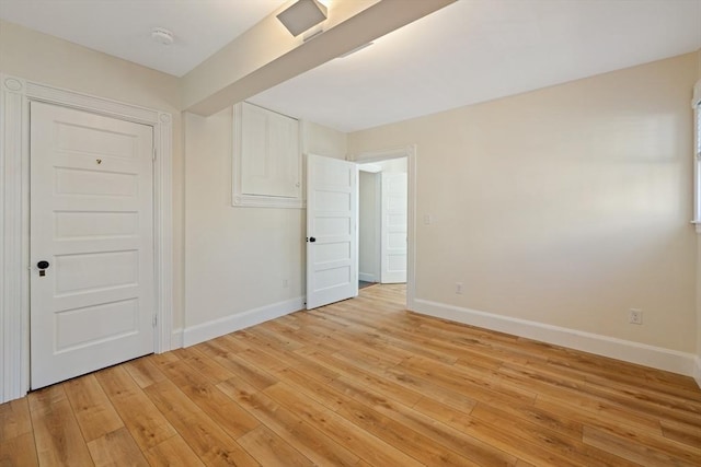 124 Boston Ave, Medford, MA 02155 - unfurnished bedroom with baseboards and light wood finished floors