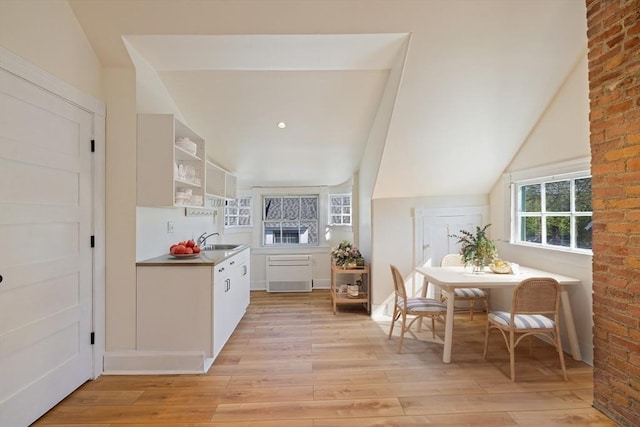 124 Boston Ave, Medford, MA 02155 - kitchen with light wood-style flooring, open shelves, white cabinetry, and a sink
