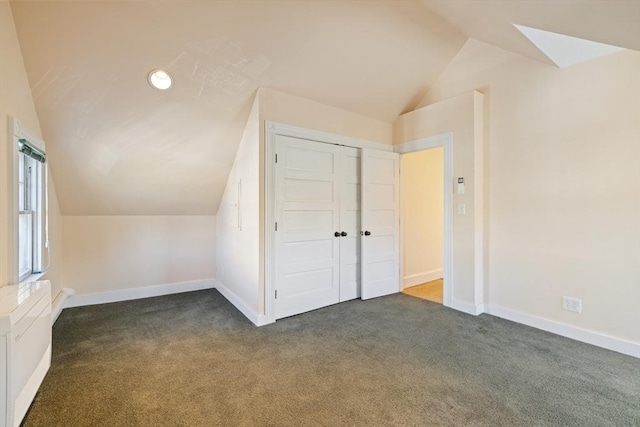 124 Boston Ave, Medford, MA 02155 - additional living space featuring lofted ceiling, dark carpet, baseboards, and a skylight