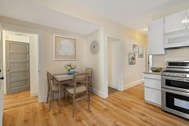 124 Boston Ave, Medford, MA 02155 - dining room with light wood-style floors and baseboards
