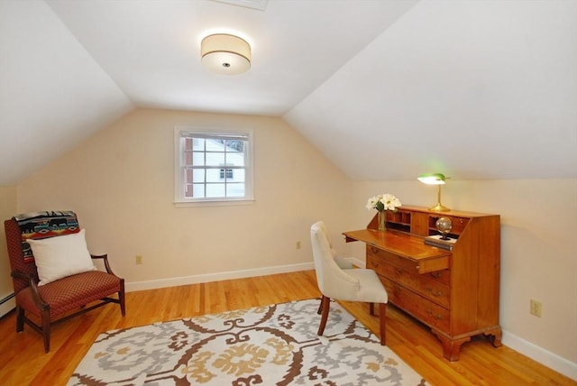 office area with baseboards, lofted ceiling, and wood finished floors