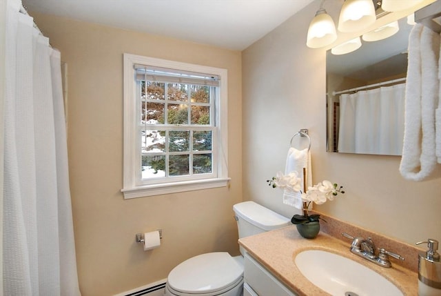 bathroom with vanity, toilet, and a baseboard heating unit