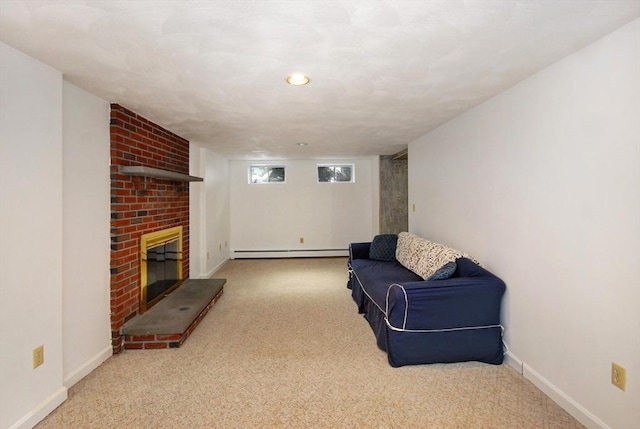 living area featuring a baseboard heating unit, baseboards, carpet, and a fireplace