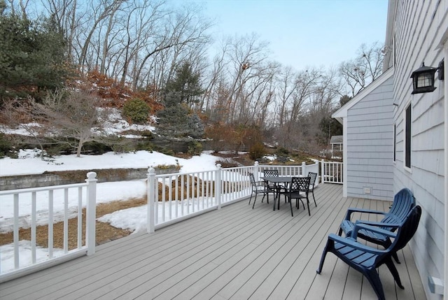 snow covered deck with outdoor dining space