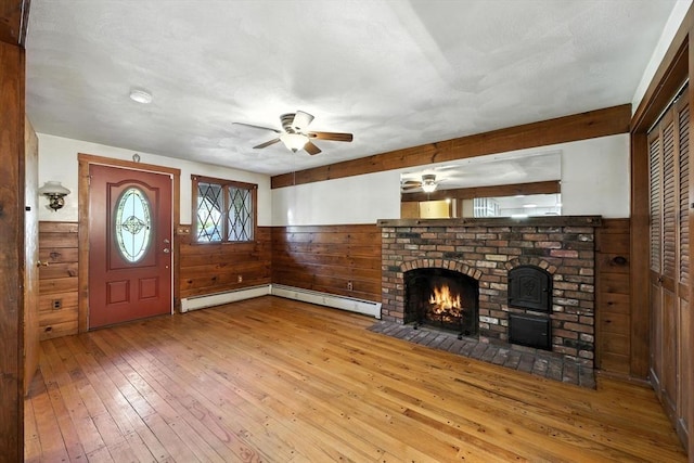 51 Glenview Dr, West Springfield, MA 01089 - unfurnished living room featuring ceiling fan, wood-type flooring, wood walls, wainscoting, and a fireplace