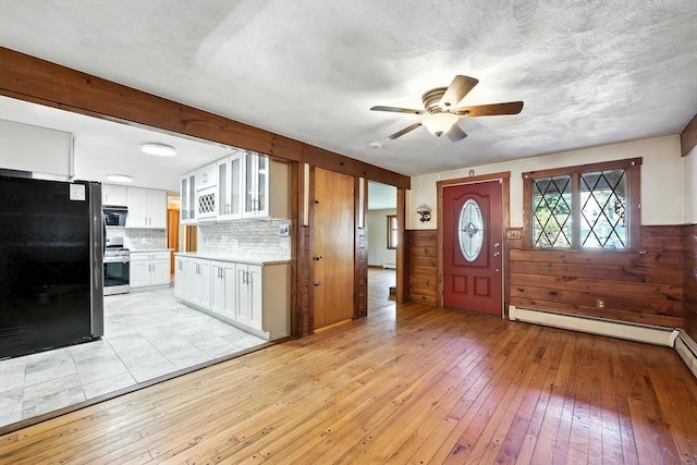 51 Glenview Dr, West Springfield, MA 01089 - foyer entrance with ceiling fan, light wood-type flooring, a baseboard heating unit, a baseboard radiator, and wainscoting