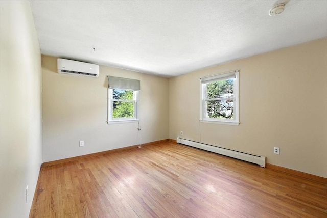 51 Glenview Dr, West Springfield, MA 01089 - empty room featuring a baseboard radiator, a wall mounted air conditioner, plenty of natural light, and light wood-type flooring