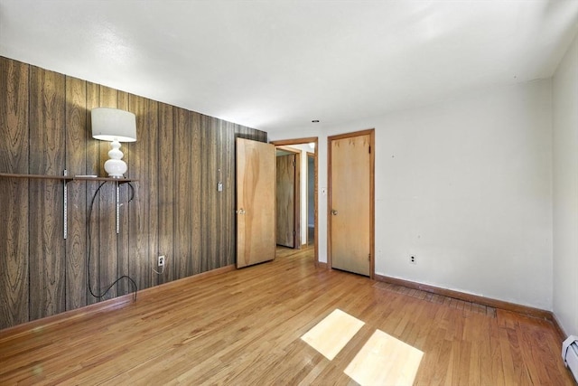 51 Glenview Dr, West Springfield, MA 01089 - unfurnished bedroom with light wood-type flooring, a baseboard radiator, and wooden walls