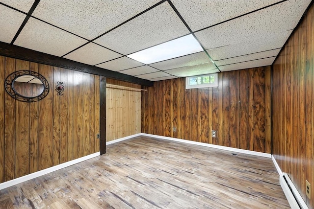 51 Glenview Dr, West Springfield, MA 01089 - basement with a baseboard radiator, wood finished floors, wood walls, and a paneled ceiling