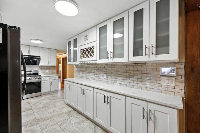51 Glenview Dr, West Springfield, MA 01089 - kitchen with stainless steel appliances, white cabinets, backsplash, light stone counters, and glass insert cabinets
