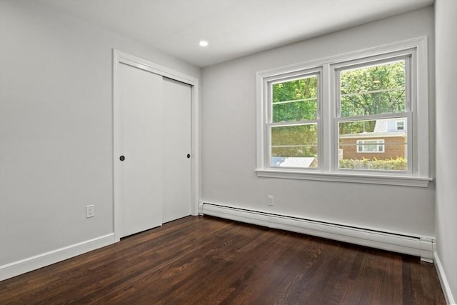 42 Stevens Ave, Braintree, MA 02184 - unfurnished bedroom with baseboard heating, dark wood-type flooring, and a closet