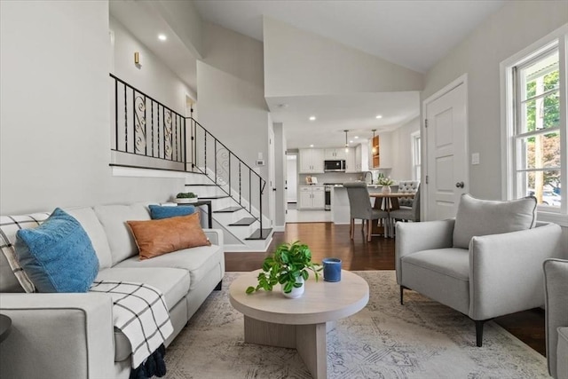 42 Stevens Ave, Braintree, MA 02184 - living room featuring healthy amount of natural light, wood finished floors, stairs, recessed lighting, and vaulted ceiling