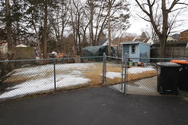 view of yard with a storage unit, fence private yard, an outdoor structure, and a gate