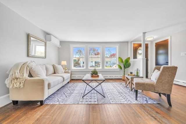 31 Darling St, Acushnet, MA 02743 - living room with a baseboard radiator, a wall mounted AC, and wood finished floors