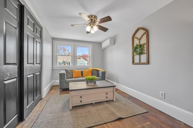31 Darling St, Acushnet, MA 02743 - sitting room featuring baseboards, a wall mounted AC, a ceiling fan, and wood finished floors