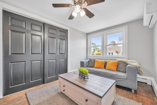 31 Darling St, Acushnet, MA 02743 - living area featuring baseboards, an AC wall unit, ceiling fan, and wood finished floors