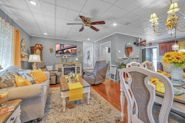 31 Darling St, Acushnet, MA 02743 - living area featuring a glass covered fireplace, ceiling fan with notable chandelier, recessed lighting, and wood finished floors