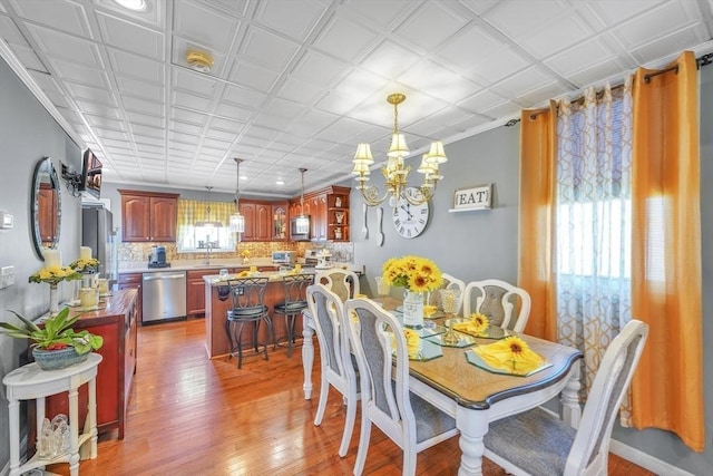 31 Darling St, Acushnet, MA 02743 - dining room with light wood-type flooring and a notable chandelier